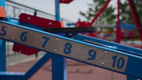 Man using weight training equipment in the gym, he chooses the right weight for Stock Footage 131620460