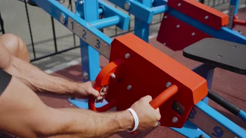 Man using a weight training machine at the gym, he is selecting the right weight 動画素材 131620161