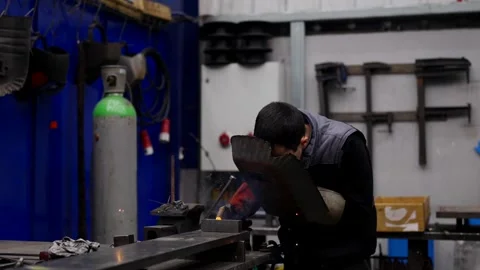 Man using welding machine in a factory Stock Footage 260847989