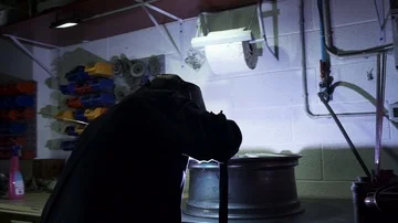 Man using welding torch on a wheel Stock Footage 86090556