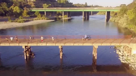 Man Using A Wheel Chair Crossing American River Stock Footage 146146385