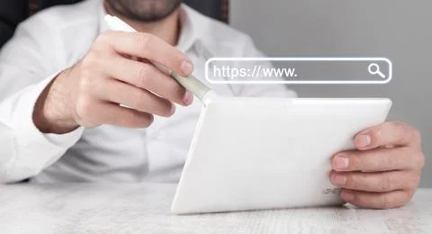 Man using white digital tablet. Https address. Internet search concept Stock Photos