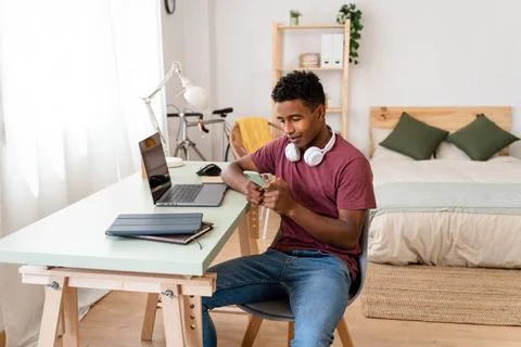 Man using wireless technology on computer while sitting indoors. Stock Photos