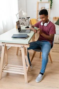 Man using wireless technology on computer while sitting indoors. Stock Photos