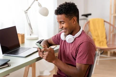 Man using wireless technology on computer while sitting indoors. Stock Photos