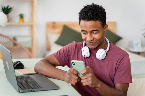 Man using wireless technology on computer while sitting indoors. Stock Photos