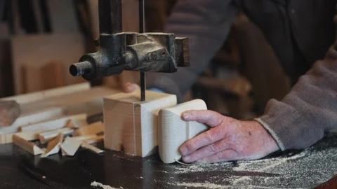 A man is using a wood saw to cut a piece of wood Stock Footage 301792978