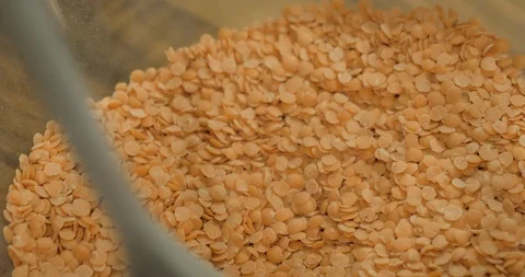 Man using a wooden cooking spoon to check lentil quality Stock Footage 99952557