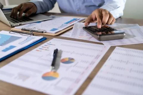 Man Usingcalculator with money stack Financial Report- Business Accounting Co Stock Photos