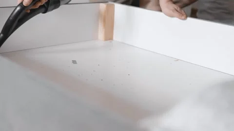 Man vacuum cleaning under the bed storage. Bedroom organization. Small space con Stock Footage 305314261