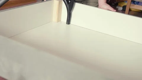 Man vacuum cleaning under the bed storage. Bedroom organization. Small space con Stock Footage 305314843