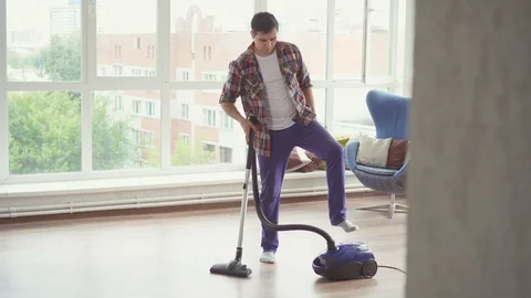Man vacuuming and dancing Stock Footage 92443443