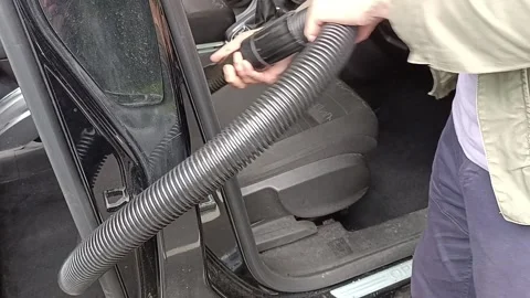 A man is vacuuming the car interior Stock Footage 277493645