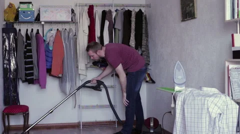 The man vacuuming the floor Stock Footage 62729572