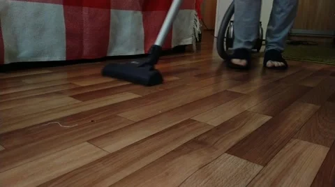 Man vacuuming the floor Stock Footage 161322743