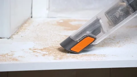 Man vacuuming with handheld vacuum cleaner sawdust after cutting wood. Cleaner. Video stock 168217577