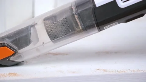 Man vacuuming with handheld vacuum cleaner sawdust after cutting wood. Cleaner. Stock Footage 170088705