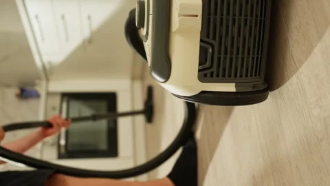 Man Vacuuming the Kitchen for a Pristine and Organized Home Setting Stock Footage 281747650