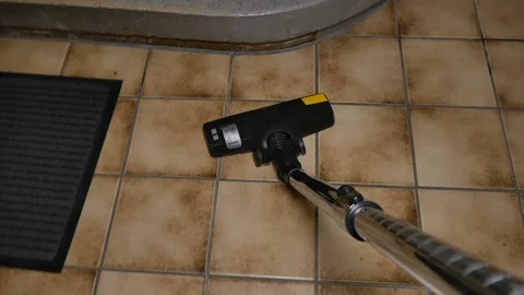 A man vacuuming at the office Stock Footage 91698488