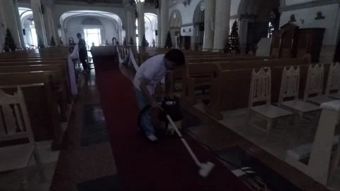 Man vacuuming red carpet inside Manila Cathedral, Intramuros, Philippines Video stock 202156727
