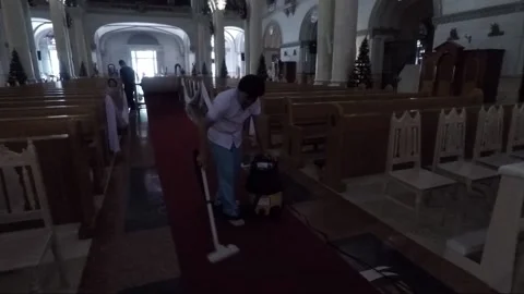 Man vacuuming red carpet inside Manila Cathedral, Intramuros, Philippines Stock Footage 202156736