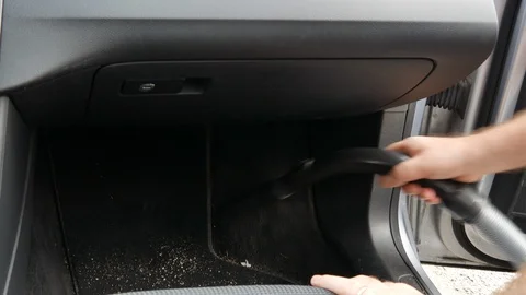 A man vacuums the car interior Stock Footage 98186792