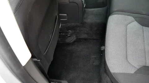 A man vacuums the car interior Stockbeeldmateriaal 98232637