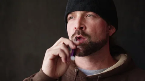 Man Vapes Smokes an E-Cigarette Stock Footage 46062622