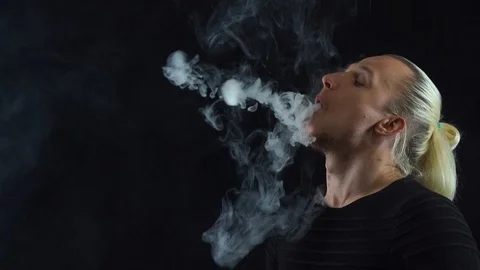 Man vaping big ring of steam and sends it to the camera with in slow motion Stock Footage 127389370