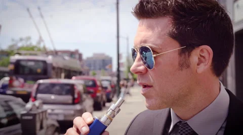 Man vaping electronic cigarette Stock Footage 64475179