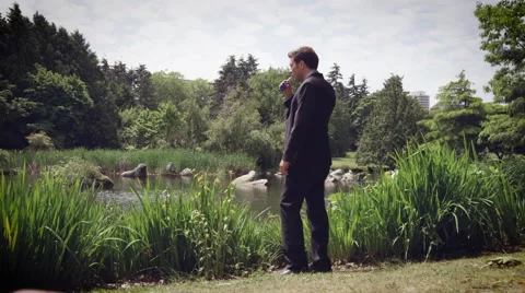 Man vaping electronic cigarette in Park Stock Footage 64454549