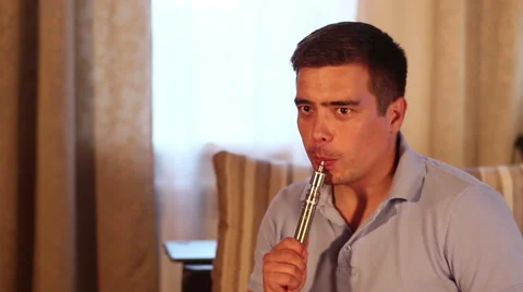 Man vaping or smoking  vaporiser (electronic nicotine delivery systems). Stock Footage 65397903