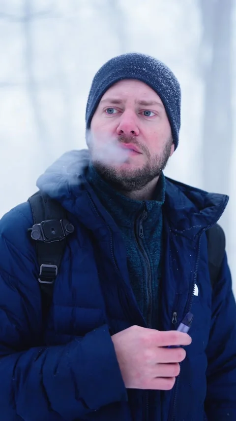 Man Vaping Outdoors in Winter – Cold Weather Portrait Stock Footage 331085449