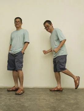 Man in Various Poses: A middle-aged man, in a casual ensemble, is captured .. Stock Photos