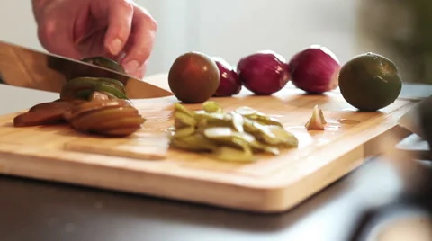 A man is vegetables a tomato into slices Stock Footage 50448221
