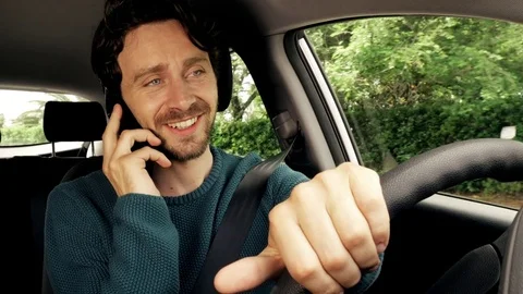 Man very much in love talking on the phone while driving at sunset Stock Footage 74753760