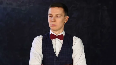 Man in a vest with a bow-tie, posing looking at camera, waving his head Stock Footage 152849198
