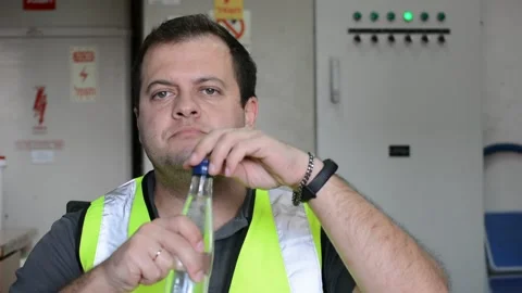 Man in vest eats slice of pizza on workplace Video stock 143449661