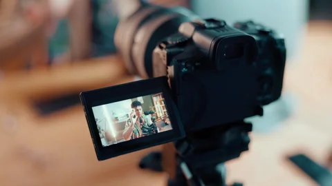 Man, video camera and screen with online tutorial for content creation or 動画素材 310448416