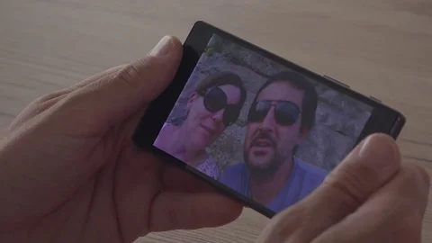Man video chatting with friends over mobile app Stock Footage