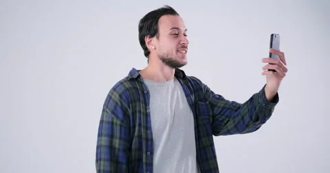 Man video chatting using mobile phone Stock Footage 143941188