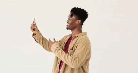 Man video chatting using mobile phone Stock Footage 156543307