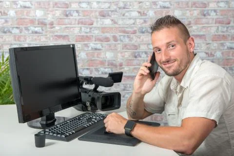 Man video editor using graphic tablet and phone Stock-Fotos
