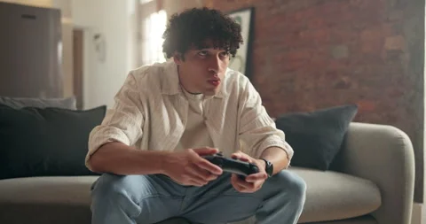 Man, video game and relax on sofa in home with online competition, challenge and Stock Footage 329393285