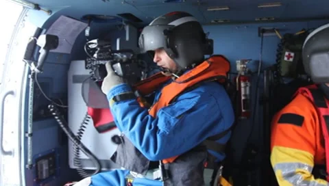 Man video taping from inside Coast Guard Helicopter(HD) c Stock Footage 8553276