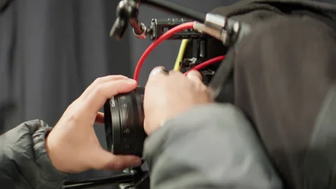 Man videographer adjusts camera lens before recording Stock-Footage 303069387