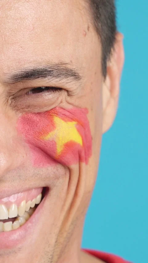 Man with a vietnamese flag painted on the face smiling Stock Footage 258242991