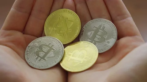 Man view and holding cryptocurrency silver and gold coins Bitcoin in his hands Stock Footage 200770373