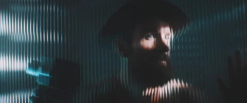 Man viewed through shutter lights and shaped clear panel Stock Footage 203565806