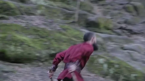 Man in Viking clothes with axes attacks another Viking with sword and shield Stock Footage 132992307